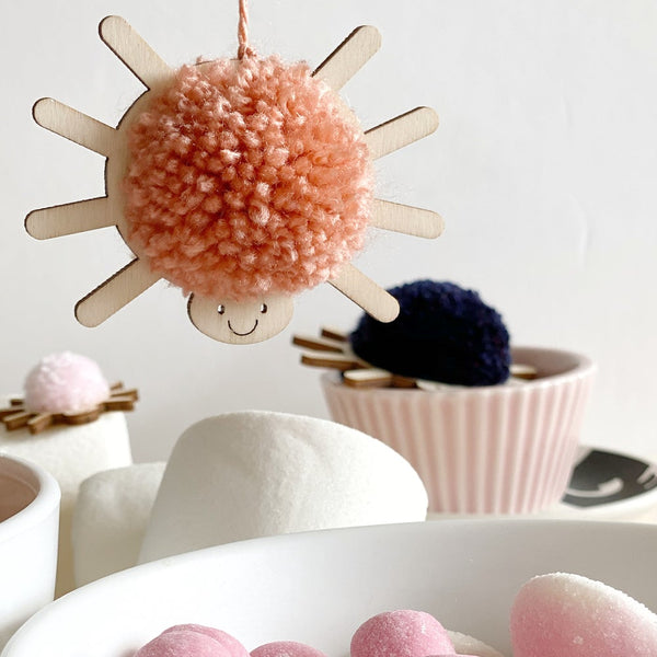 Hanging smiley pompom spider decoration with peach pompom