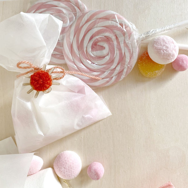 Selection of sweets with a mini pompom spider with red pompom