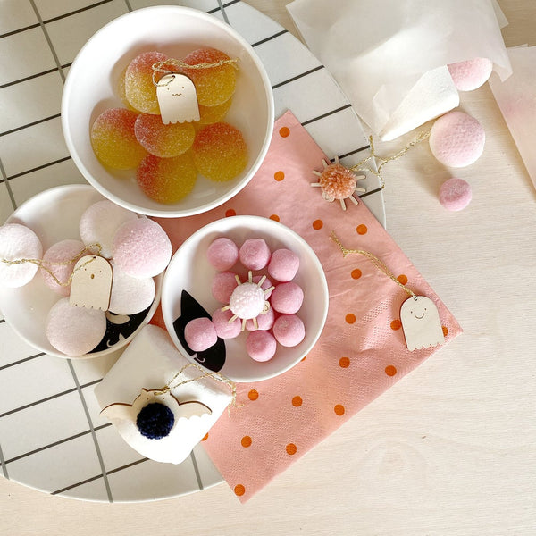 mini halloween decoration pack scattered over bowls of sweets