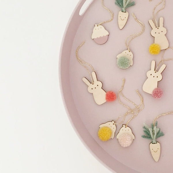 Scattered hop & hatch mini decorations on a pink plate