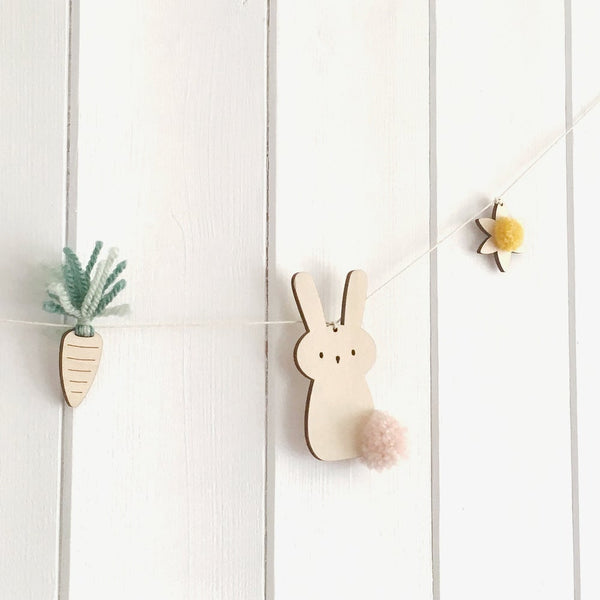 Close up of rabbit,carrot and daffodil garland with pompoms