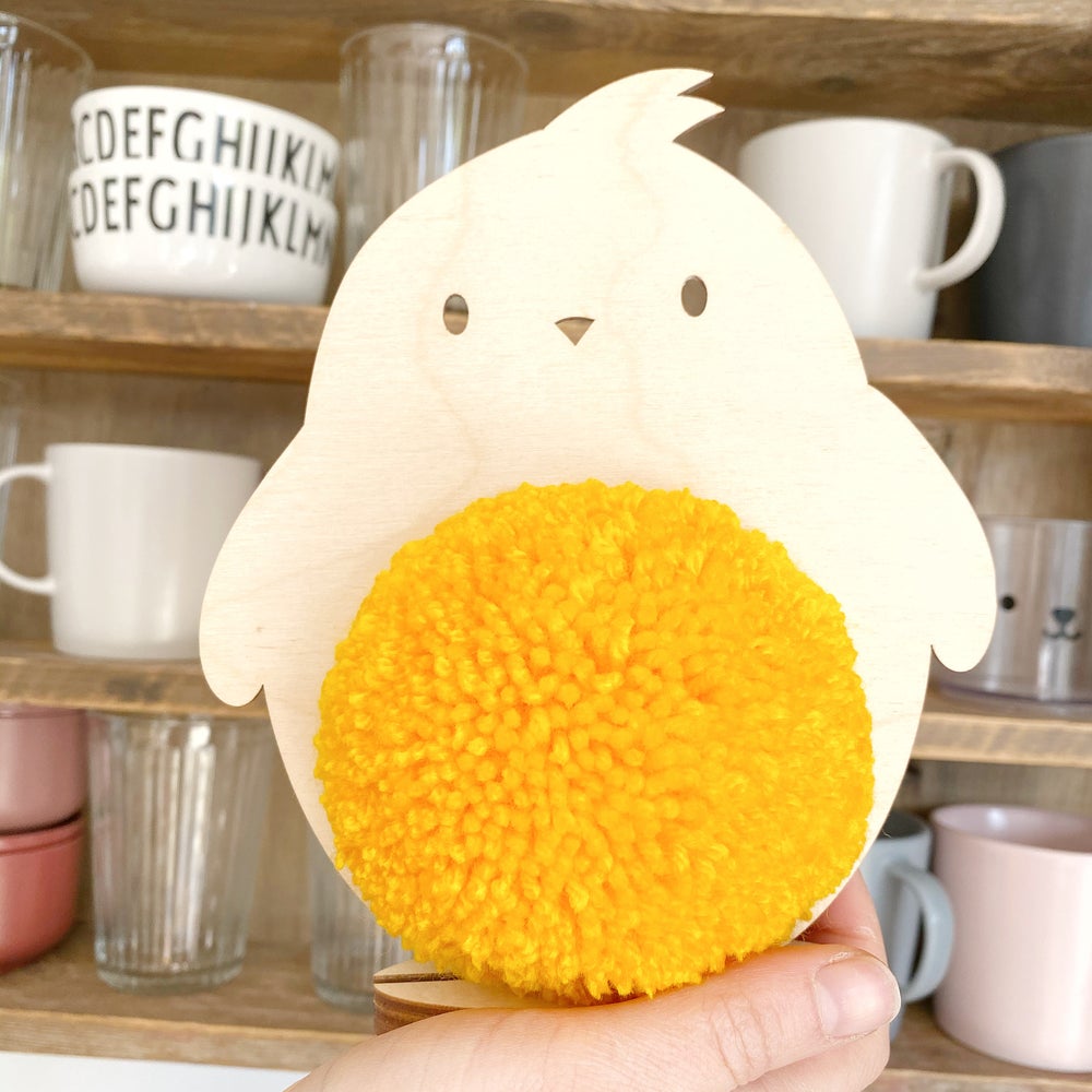 large pompom  plywood chick with yellow pom pom 