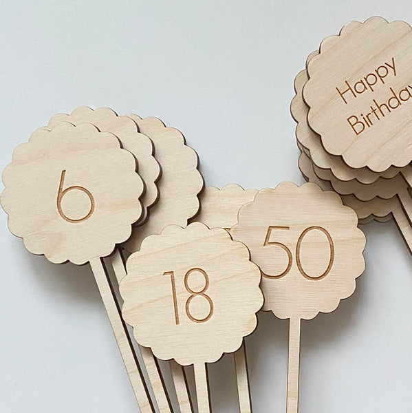Plywood Cake Toppers with an age number engraved into the wood. Happy Birthday Topper at the side.