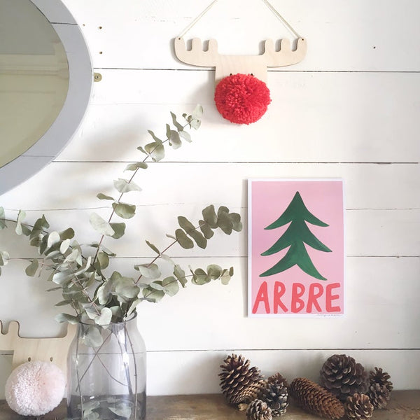 pompom reindeer decoration on wall with eucalyptus, wall art print and pinecones