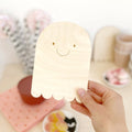 Close up of happy plywood natural halloween ghost plaque