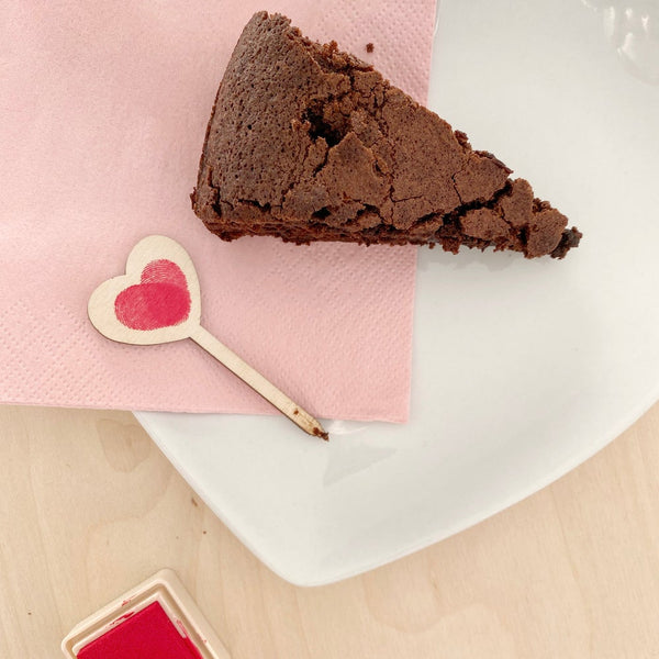 mini love heart treat topper with slice of chocolate cake
